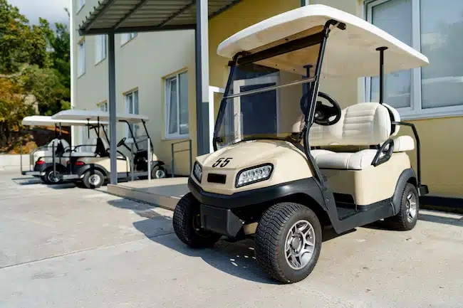 Electric golf car parked near hotel building