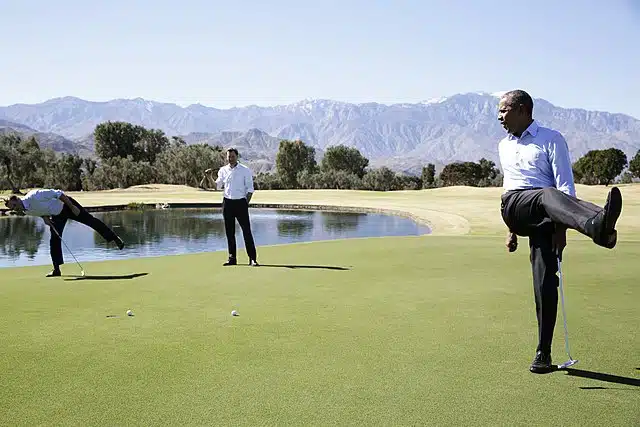 President obama kicking leg while golfing