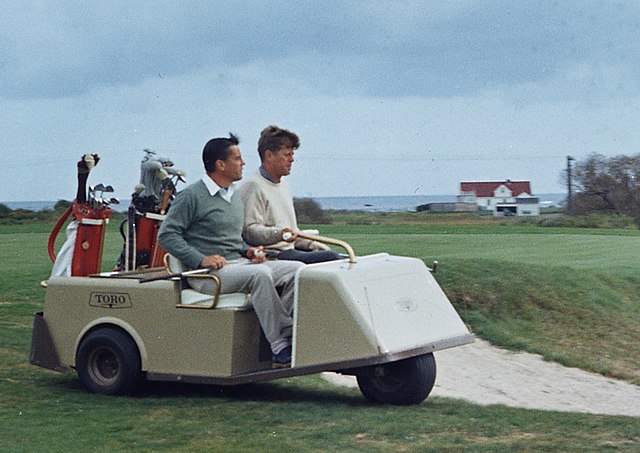 kennedy playing golf on golf cart