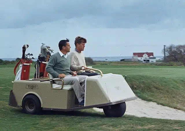 kennedy playing golf on golf cart