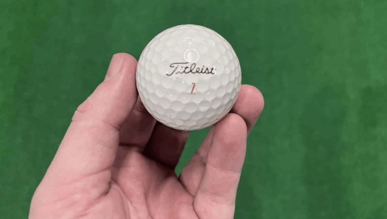 A PGA golfer holding a Titleist golf ball, number 1.