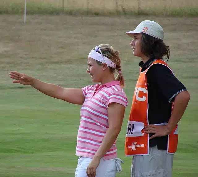 girl pointing out a shot to her golf caddy