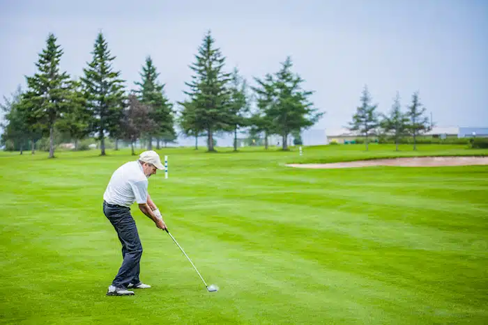 Downswing Mature Golfer on a Golf Course