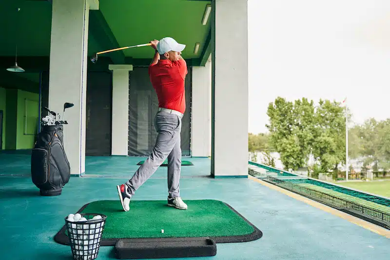 Follow through swing Sportsman swinging his club during the workout