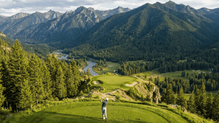 A golfer on an elevated tee overlooking a par 3.
