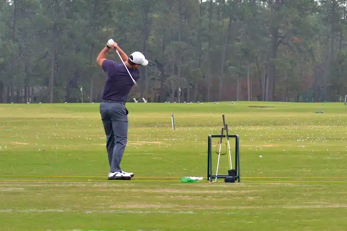 man-on-the-golf-driving-range-swinging-a-golf-club-2022-11-14-03-33-41-utc