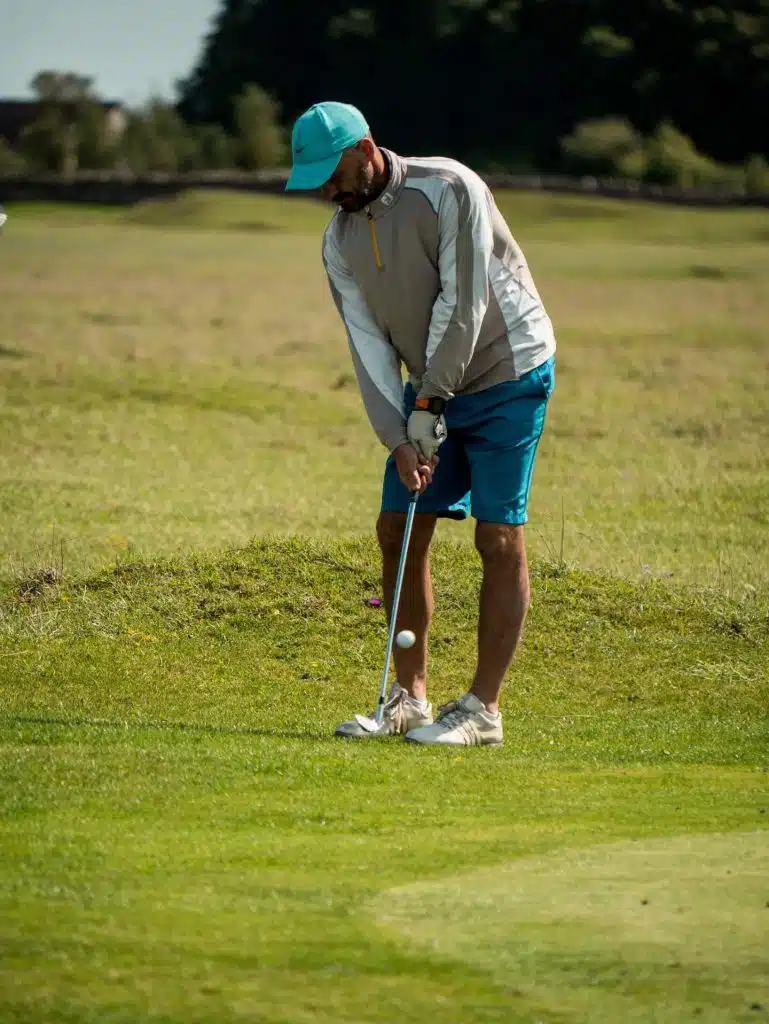 man in shorts just chipped ball