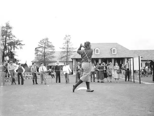 ancient man hitting golf ball on course