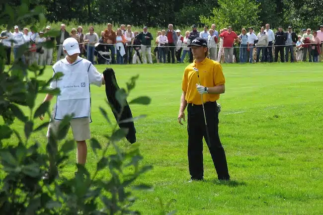 man in a pro golf tournament thinking about his shot on the golf course