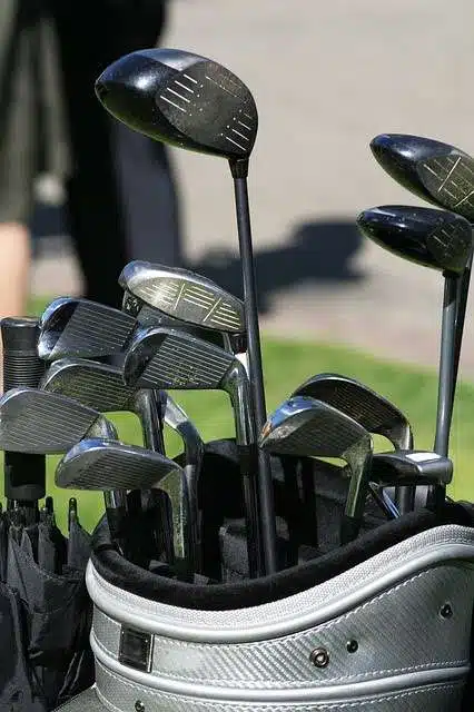 Golf clubs in a bag on course