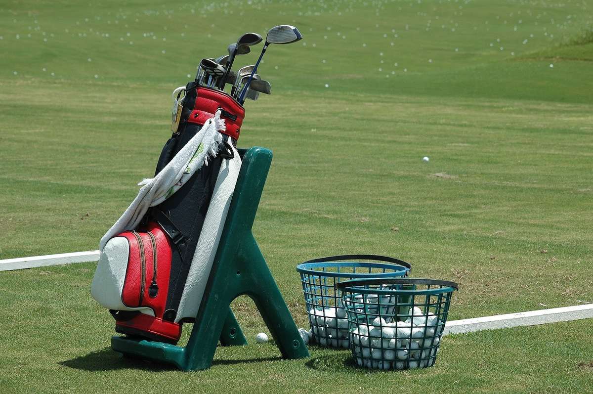 golf bag on driving range with balls
