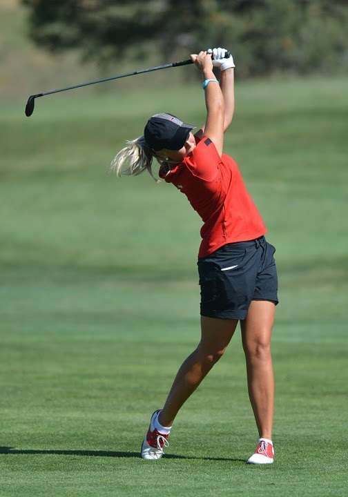 Woman hitting a drive on a golf course