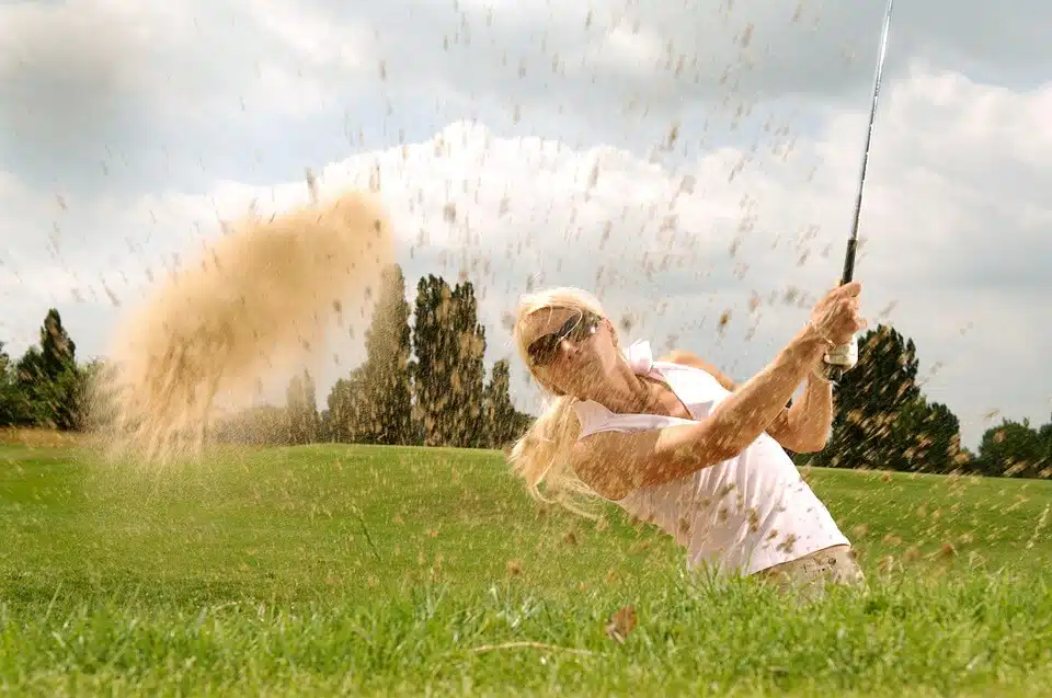 women using wedge from bunker golf