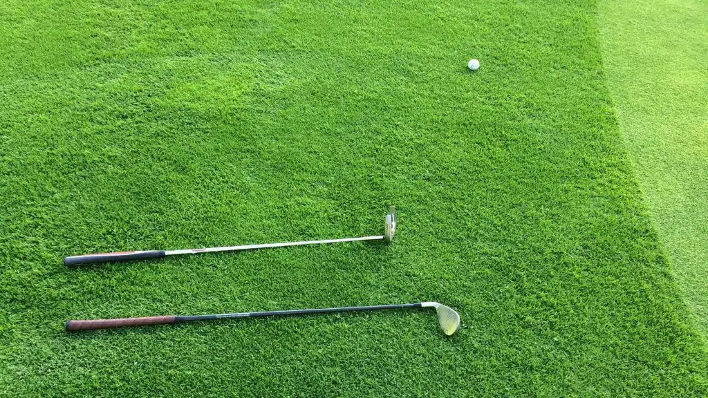 putter and chipper by green golf