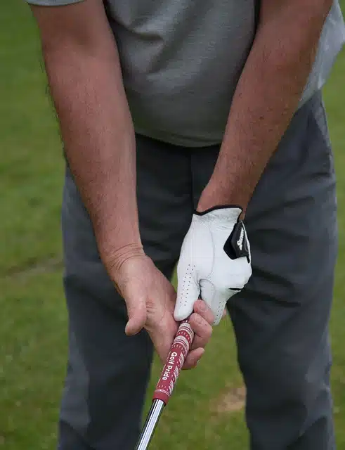 hands holding golf club grip