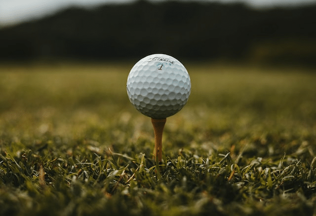 Titleist golf ball on a tee - Photo by <a href="https://unsplash.com/@will0629?utm_source=unsplash&utm_medium=referral&utm_content=creditCopyText">Will Porada</a> on <a href="https://unsplash.com/s/photos/golf-ball?utm_source=unsplash&utm_medium=referral&utm_content=creditCopyText">Unsplash</a>
