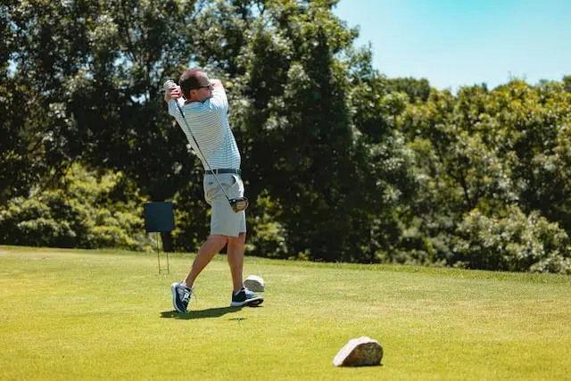 amn hitting driver on golf course