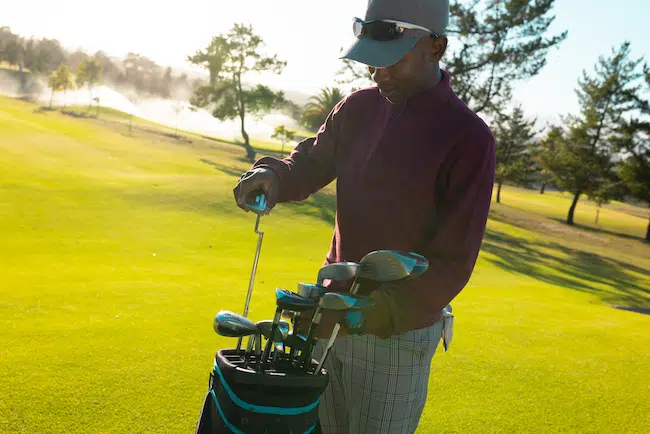 African-american-young-man-wearing-cap-putting-gol-2022-05-30-22-31-14-utc