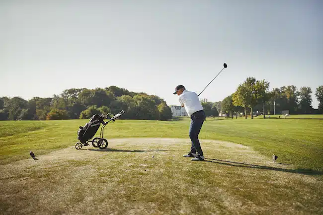 Senior man hitting his golf ball with a driver