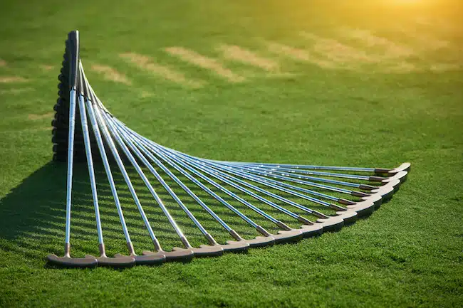 stack of golf clubs on a golf course