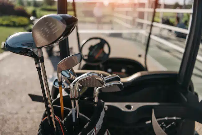 Close-up view of golf club heads in bag on the golf cart