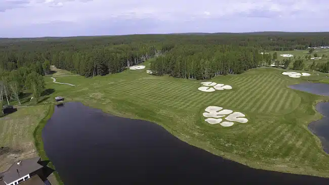 Golf course on a Sunny day, an excellent Golf club with ponds and green grass, view from the sky