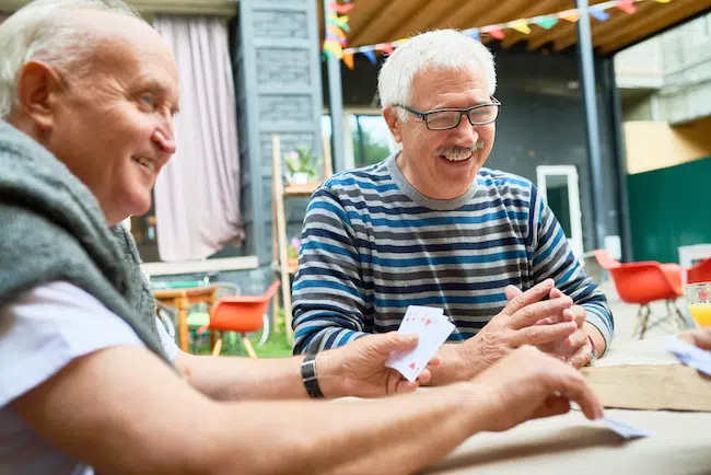 Happy-old-men-playing-card-game-2021-09-24-04-02-31-utc