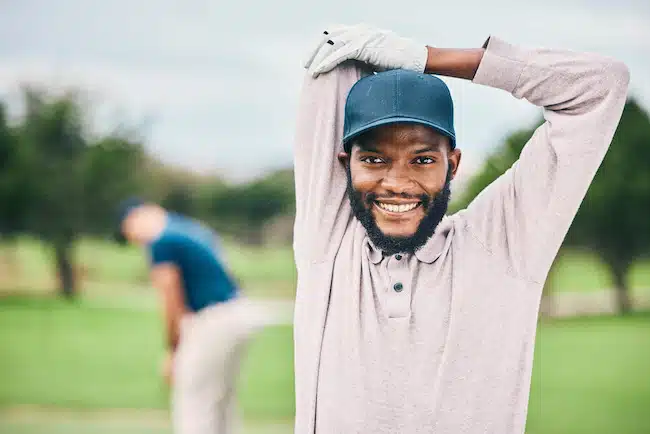 Golf, smile and portrait of black man stretching arms on course for game, practice and training for