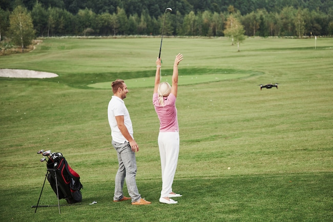 Group of stylish friends on the golf course learn to play a new game
