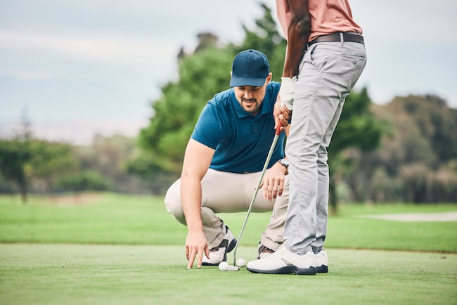 Teaching, golf lesson and sports coach help man with swing, putter and stroke outdoor. Golfing, gre