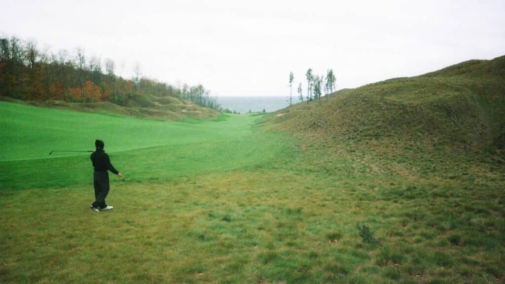 provisional ball in golf golfer hitting from rough on a cloudy day