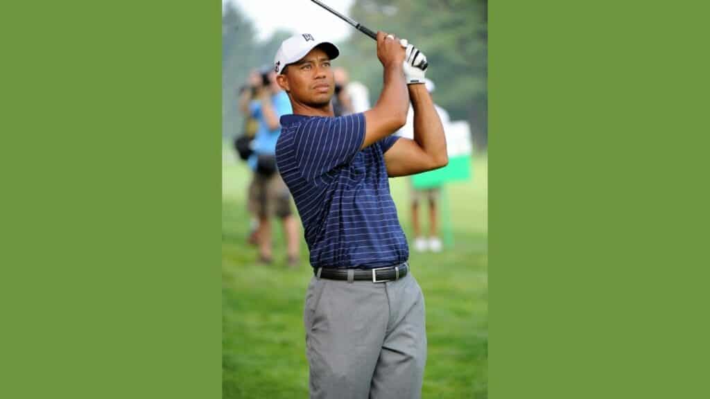 tiger woods after a hitting a shot on a golf course