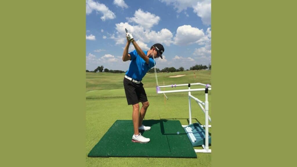 Man using a plastic tool as a training aid for golf