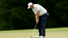 A golfer misses a putt a the Tour Championship.