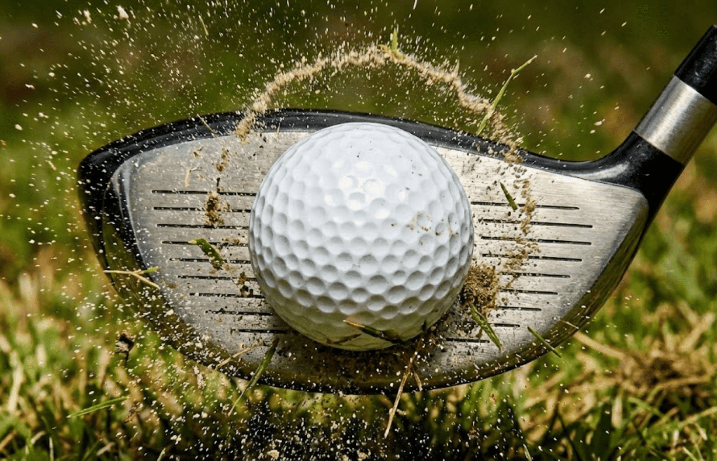 A macro, high-speed action shot capturing the exact millisecond a driver clubface strikes a golf ball.