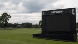 An empty LIV scoreboard on a golf course.