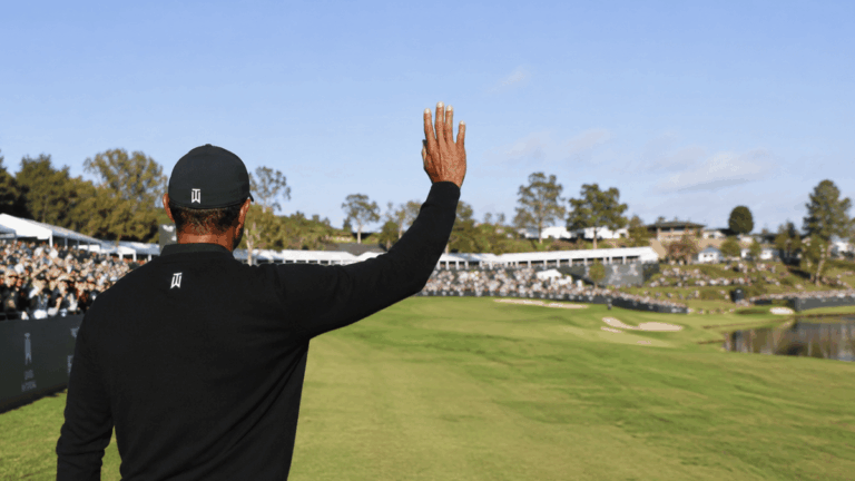 A pro golfer waving to his fans.